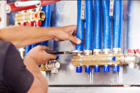 water junction with plumber working on a fitting